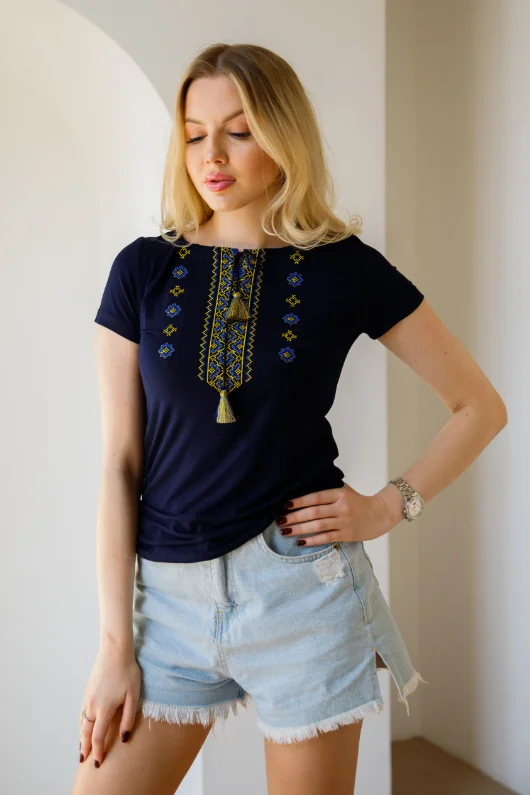 While Supplies Last Women's short sleeve navy shirt with cross-stitch embroidery. Blue and yellow